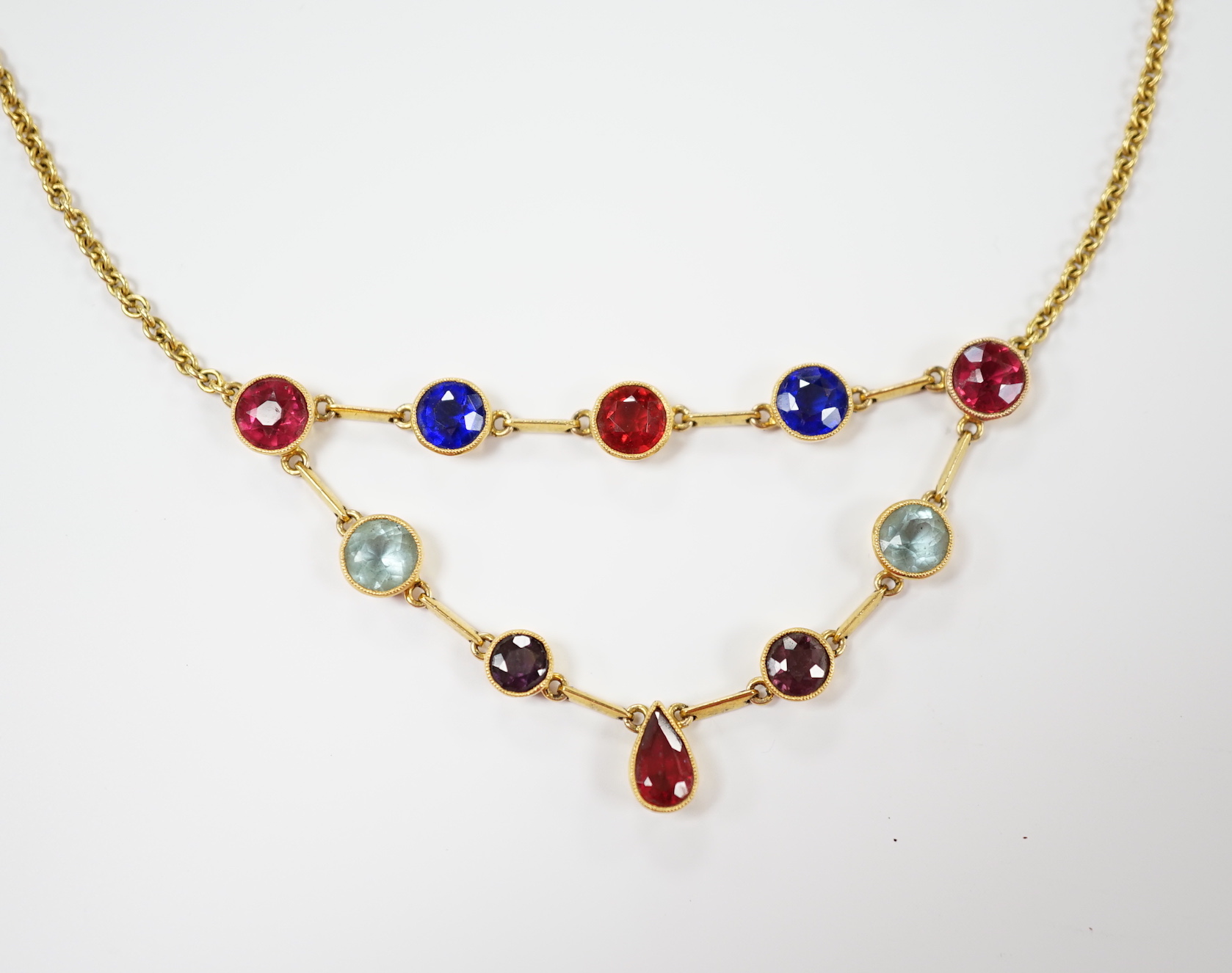 An early 20th century 15ct and ten stone multi coloured doublet set necklace, 49cm, gross weight 11.4 grams (the two pale blue stones appear not to be doublets?).